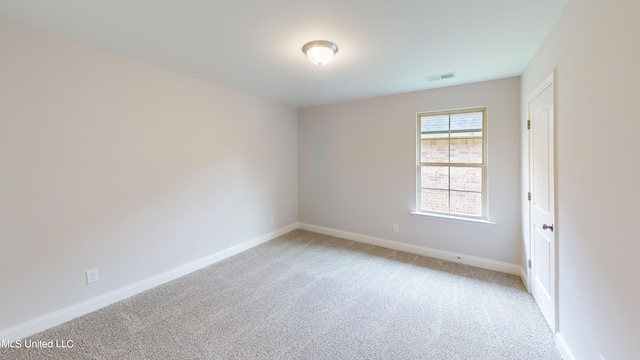 spare room with light colored carpet