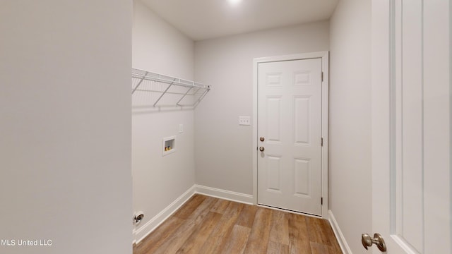 laundry room with hookup for a washing machine and light hardwood / wood-style floors