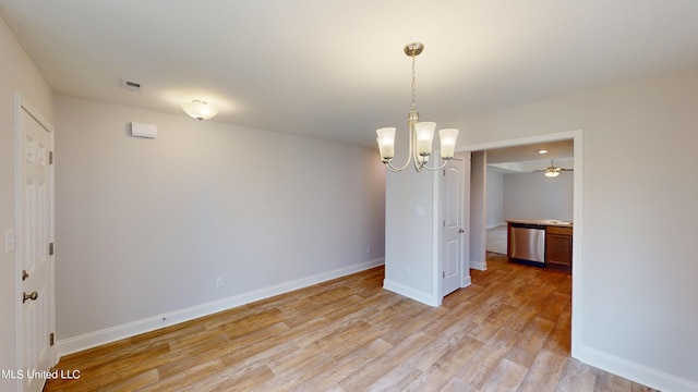 unfurnished dining area with light hardwood / wood-style flooring and ceiling fan with notable chandelier