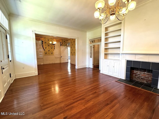 unfurnished living room featuring a fireplace, built in features, dark wood-type flooring, and crown molding