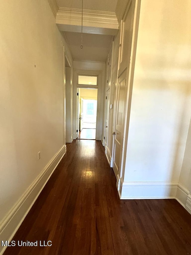 hallway featuring dark hardwood / wood-style floors and ornamental molding