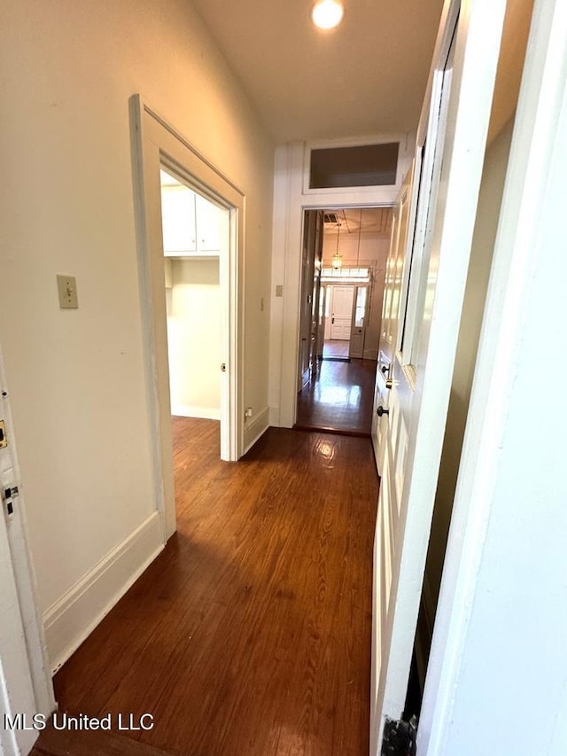 corridor featuring dark hardwood / wood-style floors