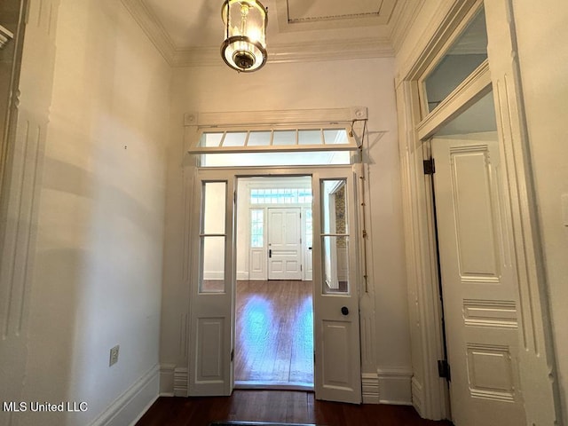 foyer entrance featuring dark hardwood / wood-style flooring and crown molding