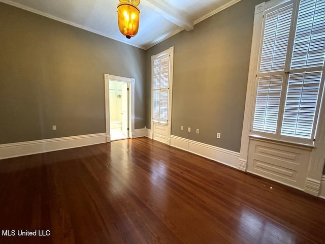 spare room with beam ceiling, dark hardwood / wood-style floors, and ornamental molding