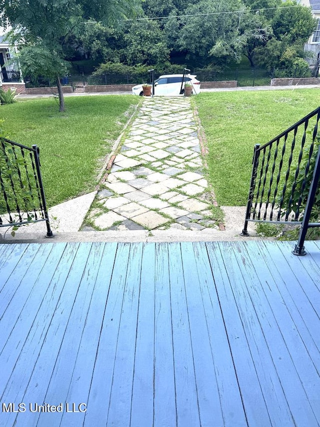 wooden terrace with a lawn