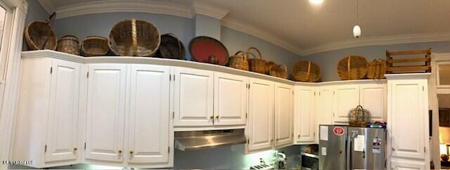 kitchen with stainless steel fridge, white cabinetry, crown molding, and range hood