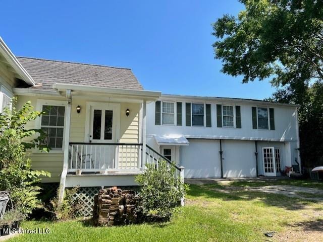 rear view of house with a lawn