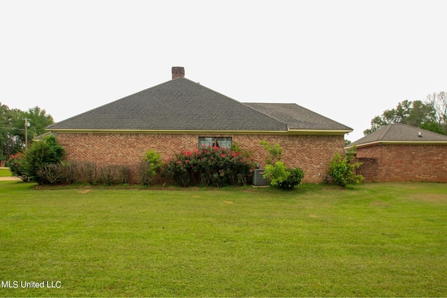 view of property exterior featuring a lawn and central AC unit