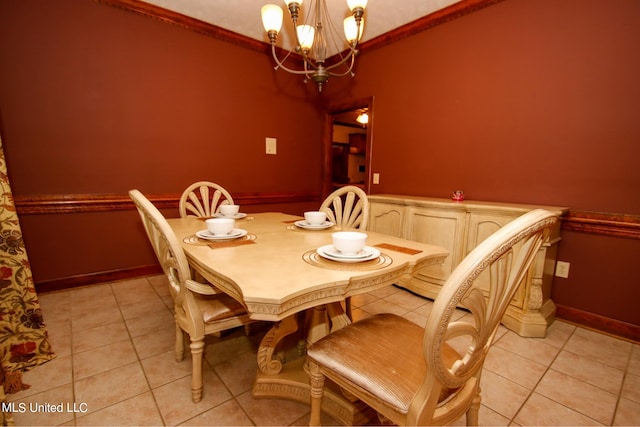 tiled dining space with crown molding and an inviting chandelier