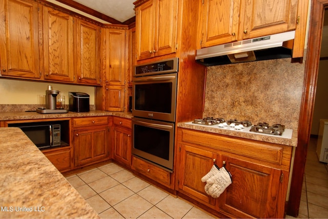 kitchen with tasteful backsplash, light tile patterned floors, white gas cooktop, and stainless steel double oven