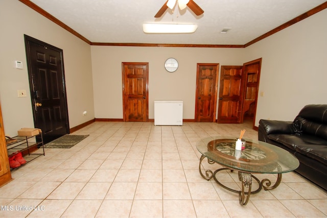 living room featuring crown molding, light tile patterned floors, and ceiling fan