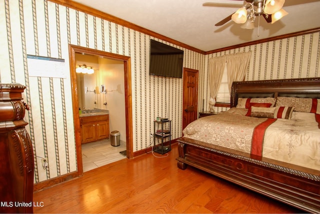 bedroom with ceiling fan, light wood-type flooring, ornamental molding, ensuite bathroom, and sink