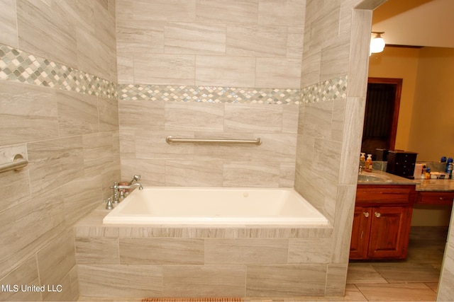 bathroom with vanity, a relaxing tiled tub, and tile patterned floors