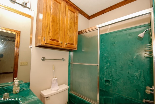 bathroom featuring toilet, ornamental molding, and walk in shower