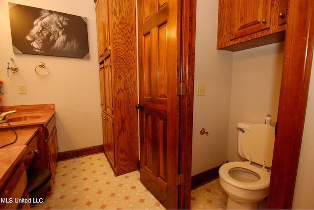 bathroom with toilet and vanity