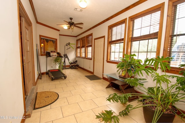 workout area featuring crown molding, light tile patterned floors, plenty of natural light, and ceiling fan