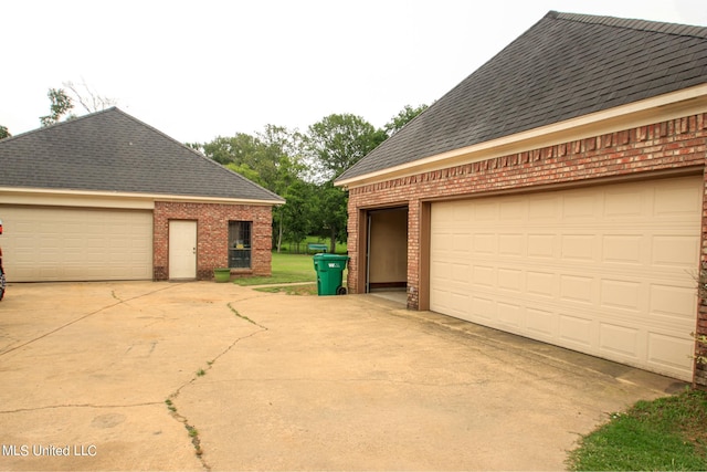 view of property exterior featuring a garage and an outbuilding