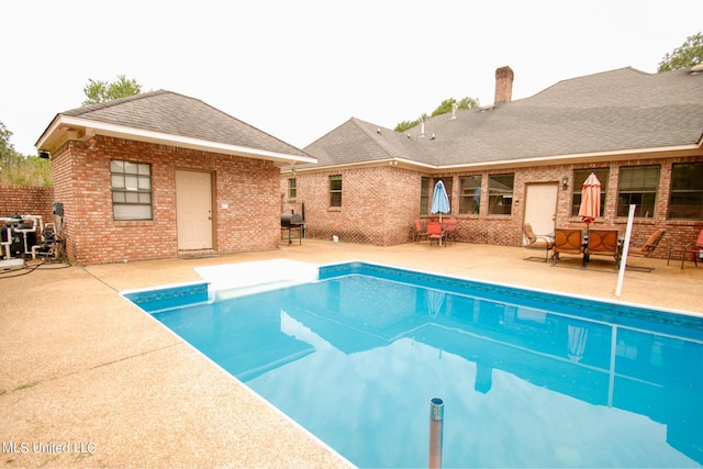 view of swimming pool with a patio