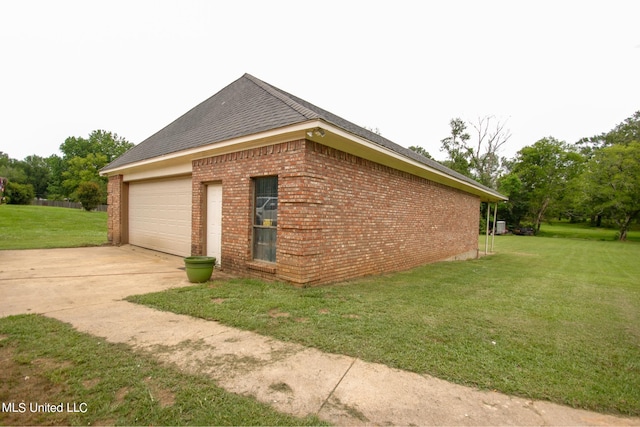 view of side of home featuring a garage and a lawn