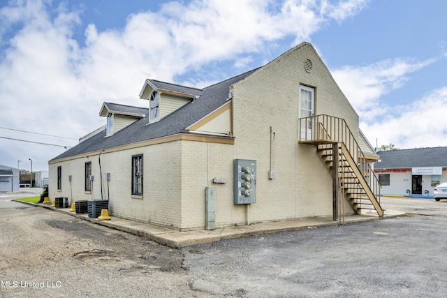 view of side of property with central air condition unit