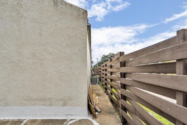 view of side of property with central air condition unit