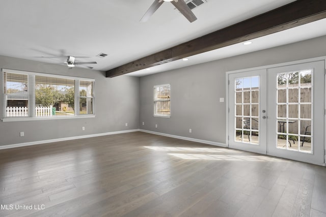 empty room with french doors, ceiling fan, hardwood / wood-style flooring, and beam ceiling