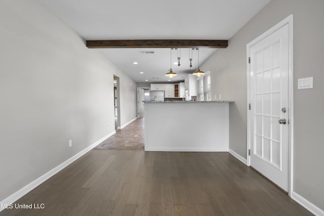 kitchen featuring hanging light fixtures, kitchen peninsula, dark hardwood / wood-style floors, stainless steel refrigerator with ice dispenser, and white cabinets