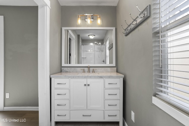 bathroom with hardwood / wood-style flooring, a shower, vanity, and plenty of natural light