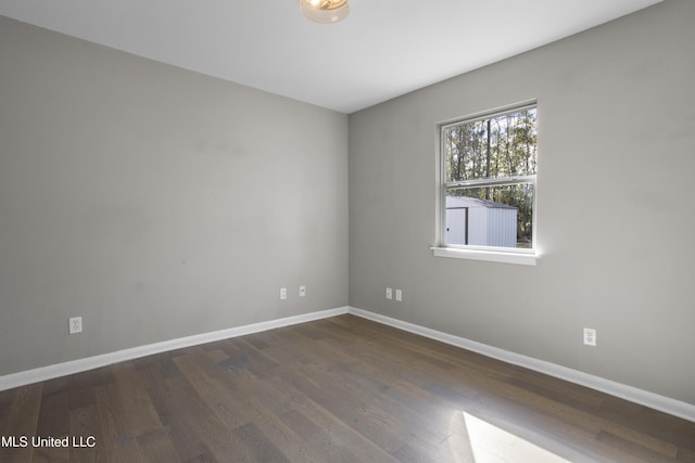 unfurnished room featuring dark hardwood / wood-style floors