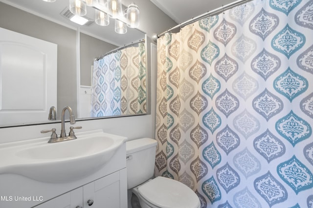 bathroom featuring ornamental molding, vanity, and toilet