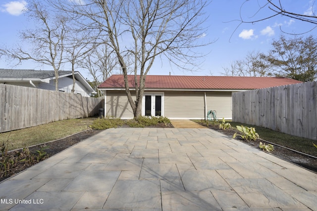 rear view of house with a patio area and french doors