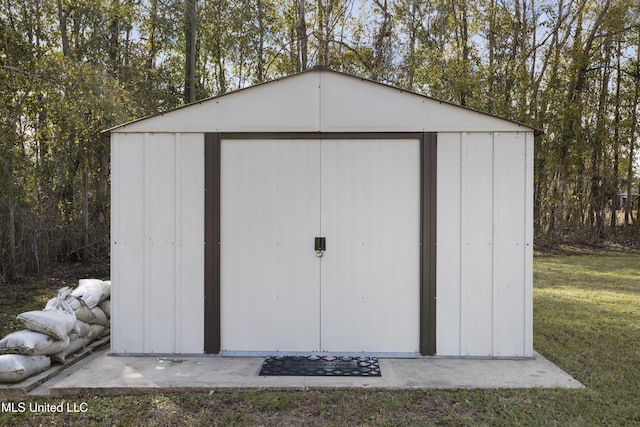 view of outdoor structure featuring a lawn