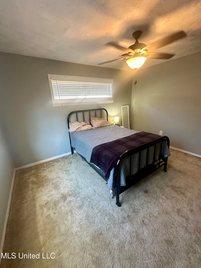 bedroom with a textured ceiling, carpet flooring, and ceiling fan