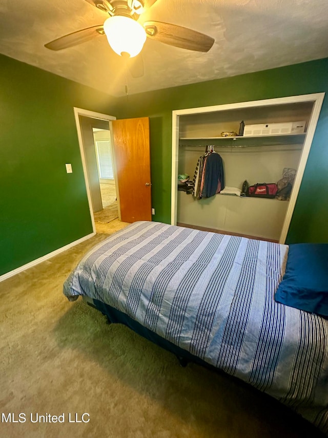 carpeted bedroom featuring a closet and ceiling fan