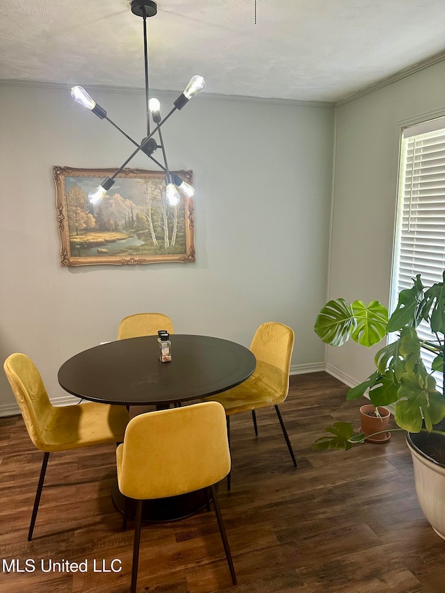 dining space featuring dark hardwood / wood-style floors and an inviting chandelier