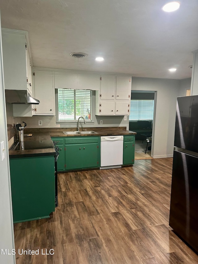 kitchen featuring white cabinets, black fridge, dark hardwood / wood-style floors, dishwasher, and sink