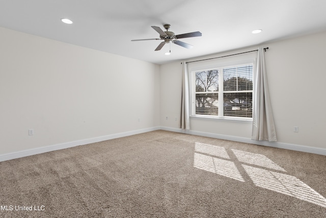 carpeted empty room featuring ceiling fan