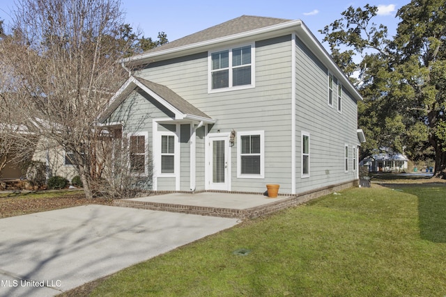 view of front of house featuring a front lawn and a patio area