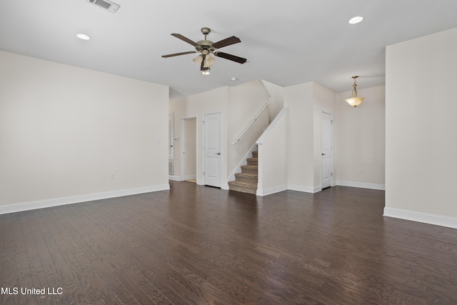 unfurnished living room featuring ceiling fan and dark hardwood / wood-style floors