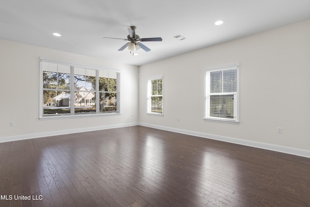 spare room with dark wood-type flooring and ceiling fan