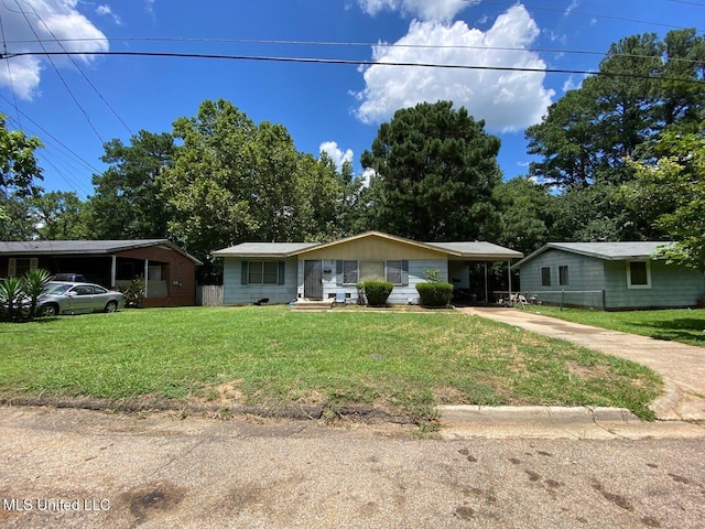 ranch-style home with a carport and a front yard