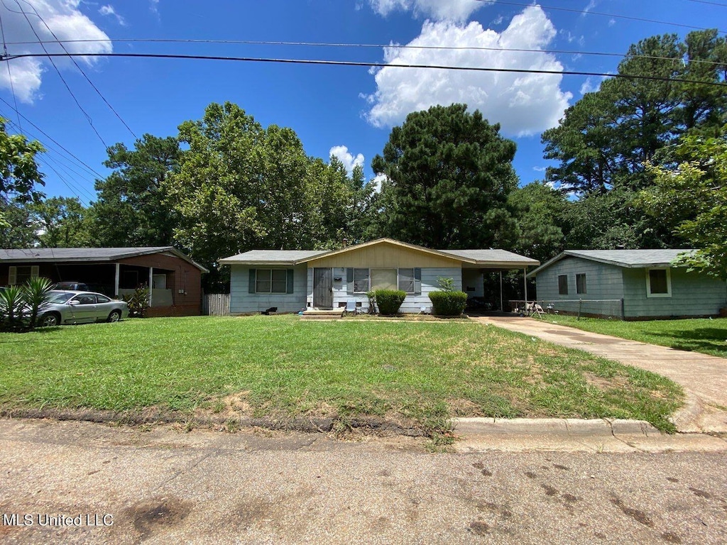 ranch-style house with concrete driveway, a front lawn, and an attached carport
