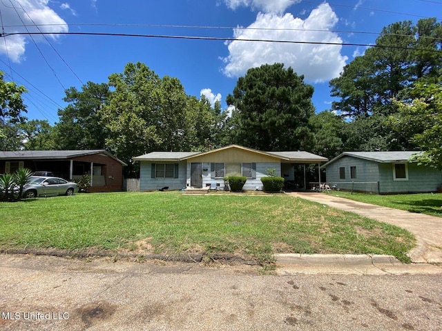 ranch-style house with concrete driveway, a front lawn, and an attached carport