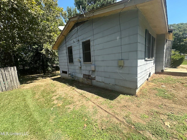 view of property exterior featuring a lawn