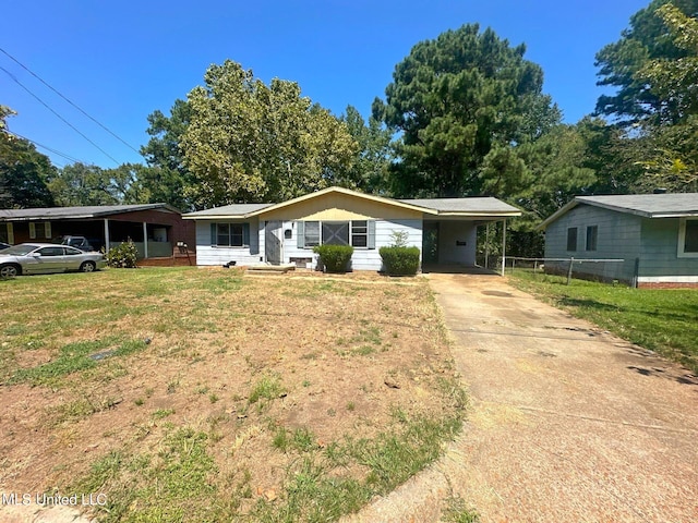 ranch-style house featuring a front lawn and a carport