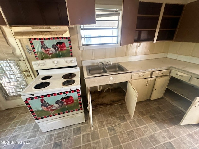 kitchen featuring decorative backsplash, sink, and electric range