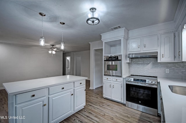 394 Woodcliff Dr, Jackson, MS 39212 - kitchen with stainless steel appliances, under cabinet range hood, visible vents, and white cabinets
