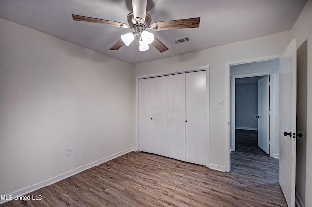 394 Woodcliff Dr, Jackson, MS 39212 - unfurnished bedroom featuring visible vents, baseboards, a closet, and wood finished floors