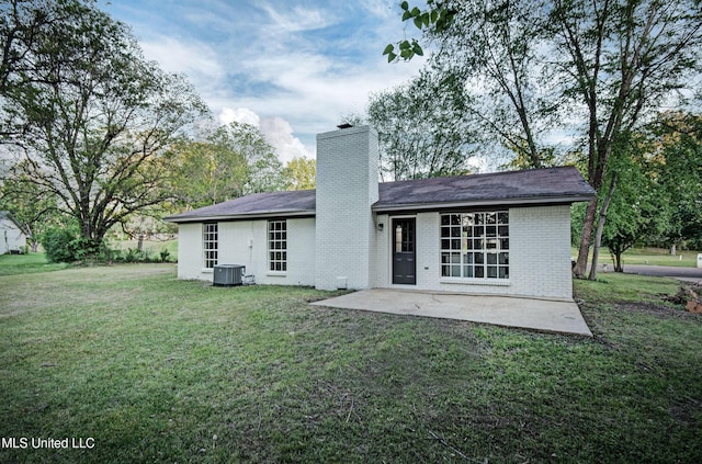 394 Woodcliff Dr, Jackson, MS 39212 - back of property featuring central AC, a patio area, a yard, a chimney, and brick siding