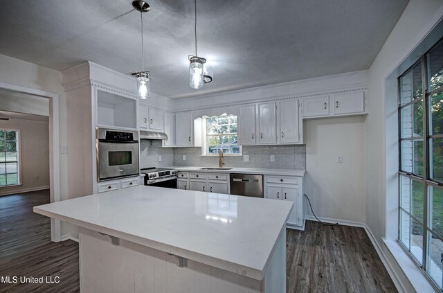 394 Woodcliff Dr, Jackson, MS 39212 - kitchen with appliances with stainless steel finishes, a sink, white cabinets, and under cabinet range hood